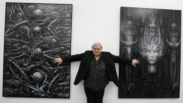 In this June 29, 2007 picture Swiss artist H.R. Giger poses with two of his works at the art museum in Chur, Switzerland. (Arno Balzarini/AP)